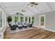 A bright sunroom with vaulted ceiling, many windows, and comfortable wicker seating arrangement at 230 Thistlewood Ln, Roswell, GA 30075