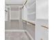 Spacious walk-in closet featuring custom storage solutions and well-lit interior at 230 Thistlewood Ln, Roswell, GA 30075