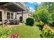 Beautiful backyard featuring a covered patio, lush green lawn, and landscaped garden at 4486 Huffman Drive Ne Dr, Roswell, GA 30075
