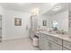 Bathroom featuring double vanities, grey cabinetry, granite countertops, tiled floors and bright lighting at 4486 Huffman Drive Ne Dr, Roswell, GA 30075