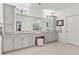 Bathroom with double vanities, grey cabinetry, granite countertops, tiled floors and view to glass enclosed shower at 4486 Huffman Drive Ne Dr, Roswell, GA 30075