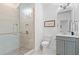 Modern bathroom featuring a glass shower, gray vanity, tile flooring and updated fixtures at 4486 Huffman Drive Ne Dr, Roswell, GA 30075