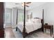 Bedroom with four poster bed, hardwood floors, and shutters at 4486 Huffman Drive Ne Dr, Roswell, GA 30075
