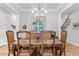 Formal dining room featuring coffered ceiling, designer chandelier, and hardwood floors at 4486 Huffman Drive Ne Dr, Roswell, GA 30075