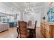 Open concept dining room with hardwood floors connecting to kitchen and living room at 4486 Huffman Drive Ne Dr, Roswell, GA 30075