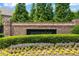 Landscaped entrance to Havenridge community with brick sign, flowering shrubs, and mature trees at 4486 Huffman Drive Ne Dr, Roswell, GA 30075