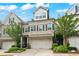 Charming townhome with brick facade, two-car garage, landscaped front yard, and mature trees at 4486 Huffman Drive Ne Dr, Roswell, GA 30075