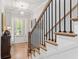 Welcoming foyer with hardwood floors, staircase, elegant lighting, and stylish decor at 4486 Huffman Drive Ne Dr, Roswell, GA 30075