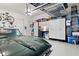 Well-organized garage featuring storage cabinets, epoxy floors, overhead racks, and a classic car at 4486 Huffman Drive Ne Dr, Roswell, GA 30075