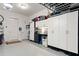 Spacious garage with epoxy floors, ample storage cabinets, and a well-organized workspace at 4486 Huffman Drive Ne Dr, Roswell, GA 30075