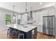 Modern kitchen with an island, stainless steel appliances, pendant lighting, and hardwood floors at 4486 Huffman Drive Ne Dr, Roswell, GA 30075