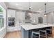 Contemporary kitchen features a large island, modern appliances, and white cabinetry at 4486 Huffman Drive Ne Dr, Roswell, GA 30075