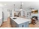 Kitchen island with seating, stainless steel appliances, and an open floor plan at 4486 Huffman Drive Ne Dr, Roswell, GA 30075