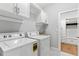 Laundry room with washer, dryer, sink, and cabinets at 4486 Huffman Drive Ne Dr, Roswell, GA 30075