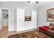 Sitting room with hardwood floors, ceiling fan, and a custom cabinet with a television sitting on it at 4486 Huffman Drive Ne Dr, Roswell, GA 30075