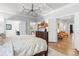 Spacious main bedroom with a coffered ceiling, chandelier, hardwood floors, and views to the ensuite bathroom and sitting area at 4486 Huffman Drive Ne Dr, Roswell, GA 30075