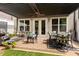 Inviting patio with pergola, outdoor seating, lush greenery, and manicured lawn at 4486 Huffman Drive Ne Dr, Roswell, GA 30075