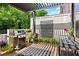 Well-equipped patio with grill, dining area, and lush greenery, perfect for outdoor entertaining at 4486 Huffman Drive Ne Dr, Roswell, GA 30075
