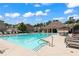 Community pool with tanning ledge, lounge chairs, umbrellas, and a bathhouse in the background at 4486 Huffman Drive Ne Dr, Roswell, GA 30075