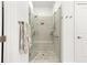 Glass enclosed shower with pebble floor and tiled walls at 4486 Huffman Drive Ne Dr, Roswell, GA 30075