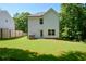 Back exterior view of home with a large grassy backyard at 5350 Mercedes Dr, Cumming, GA 30041