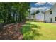View of a large, grassy backyard with wooden privacy fence at 5350 Mercedes Dr, Cumming, GA 30041