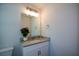 Bathroom featuring granite vanity with modern lighting, hardware, and a large mirror at 5350 Mercedes Dr, Cumming, GA 30041
