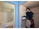 Bathroom and walk-in closet with wire shelving and clothes racks at 5350 Mercedes Dr, Cumming, GA 30041
