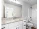 Bathroom featuring white cabinets, granite countertops, and a shower-tub combination at 5350 Mercedes Dr, Cumming, GA 30041