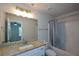 Bathroom featuring white cabinets, granite countertops, and a shower-tub combination with curtain at 5350 Mercedes Dr, Cumming, GA 30041