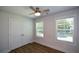 Cozy bedroom featuring natural light, neutral walls, wood floors, and a ceiling fan at 5350 Mercedes Dr, Cumming, GA 30041