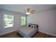 Bright bedroom with wood floors, ceiling fan, and two windows at 5350 Mercedes Dr, Cumming, GA 30041