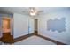 Bedroom features wood flooring and an interesting geometric wall decoration at 5350 Mercedes Dr, Cumming, GA 30041