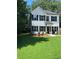 Beautifully landscaped lawn and two-story home featuring black shutters and a classic, inviting design at 5350 Mercedes Dr, Cumming, GA 30041