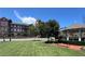 Scenic view of a well-maintained community area with lush green lawn, gazebo, and brick building under a clear blue sky at 5350 Mercedes Dr, Cumming, GA 30041