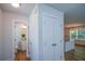 Hallway view leading to bathroom and kitchen area featuring a closet for storage at 5350 Mercedes Dr, Cumming, GA 30041