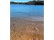 Picturesque lakefront view with clear waters and a boat visible in the distance, showcasing the natural beauty at 5350 Mercedes Dr, Cumming, GA 30041