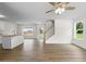 Bright, open-concept living room featuring hardwood floors, a ceiling fan, and a view to the backyard at 5350 Mercedes Dr, Cumming, GA 30041