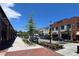 Street view of a vibrant shopping center with brick sidewalks and a variety of retail stores at 5350 Mercedes Dr, Cumming, GA 30041