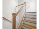 Close-up of staircase featuring wooden handrail and white spindles leading to the second floor at 5350 Mercedes Dr, Cumming, GA 30041