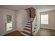 Open staircase with wood treads and white risers, leading to the upper level of the home at 5350 Mercedes Dr, Cumming, GA 30041