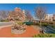 A quaint town square with benches, trees, and a view of local buildings under a clear blue sky at 5350 Mercedes Dr, Cumming, GA 30041