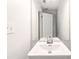 Bathroom featuring a pedestal sink, mirror, and white door at 1269 Gates Se Cir, Atlanta, GA 30316