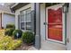 Welcoming front entrance with a vibrant red door, well-kept bushes and green plants at 1269 Gates Se Cir, Atlanta, GA 30316