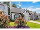 Beautiful front exterior with lush landscaping and a well-maintained lawn under a blue sky at 1269 Gates Se Cir, Atlanta, GA 30316