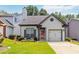 Charming home featuring a red front door, an attached garage, and well-manicured front lawn at 1269 Gates Se Cir, Atlanta, GA 30316