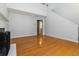 Spacious living room with hardwood floors, a view of an upstairs loft, and a glimpse into the bathroom at 1269 Gates Se Cir, Atlanta, GA 30316