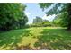 Expansive backyard with lush green grass and mature trees creating a private and tranquil outdoor space at 2581 N Clark Dr, Atlanta, GA 30344