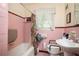 Bathroom featuring pink tile, with tub and shower and window with natural light at 2581 N Clark Dr, Atlanta, GA 30344