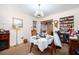 Cozy dining area with built-in shelves filled with mugs, complemented by a charming chandelier and ample natural light at 2581 N Clark Dr, Atlanta, GA 30344